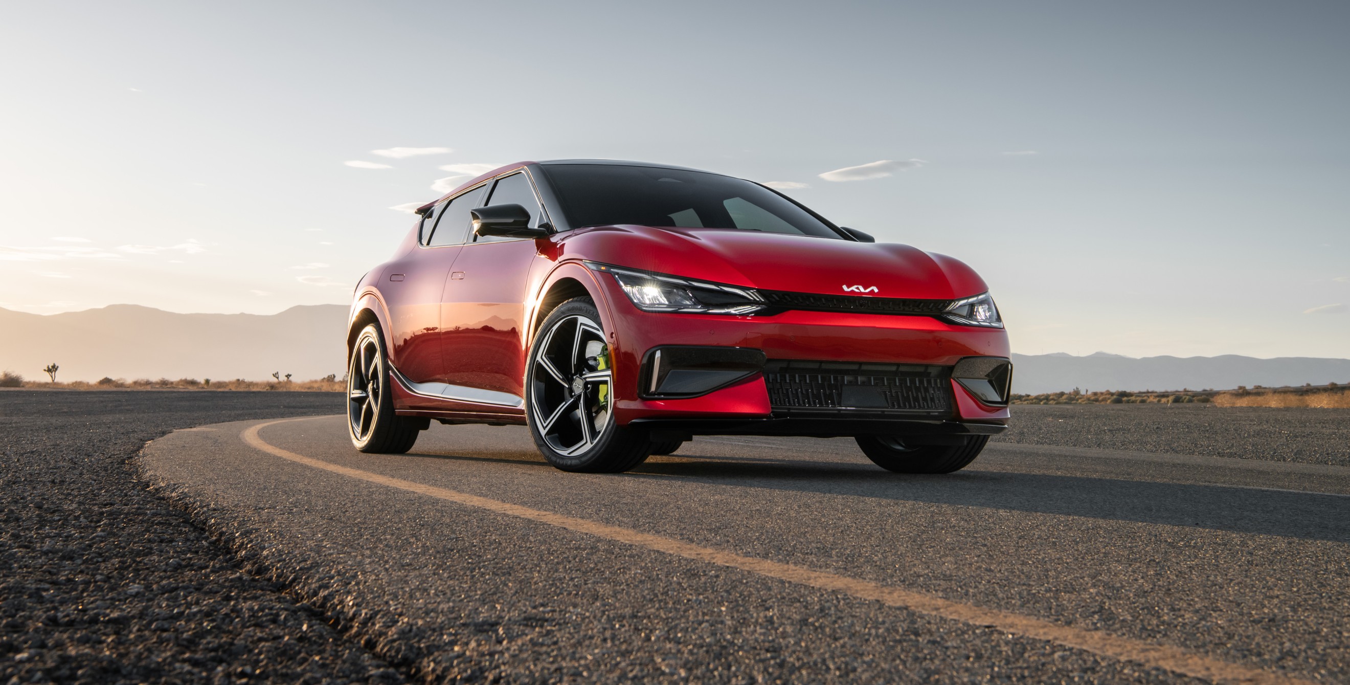 A red 2023 Kia EV6 GT on a closed track.