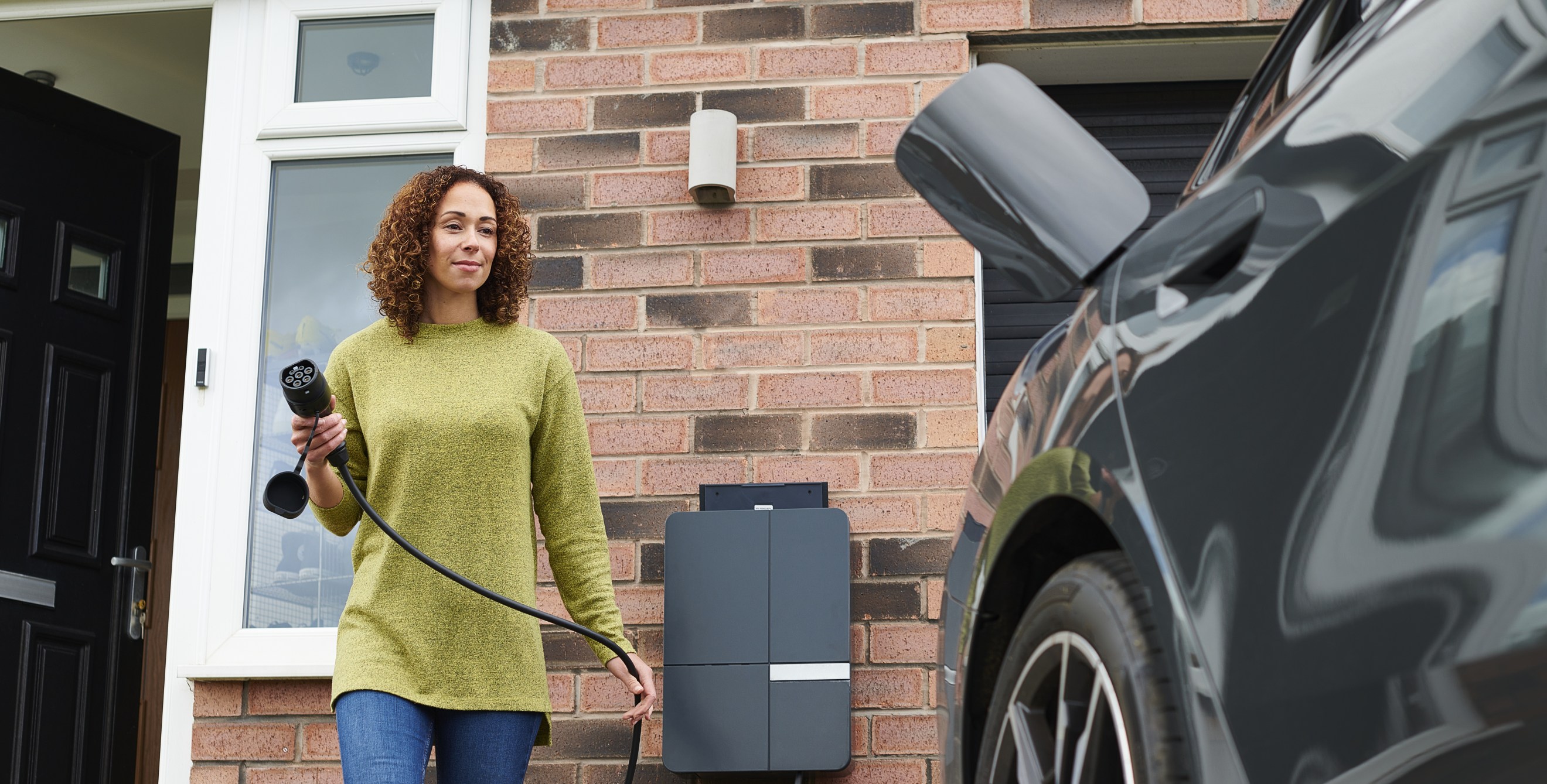 Woman charging her EV