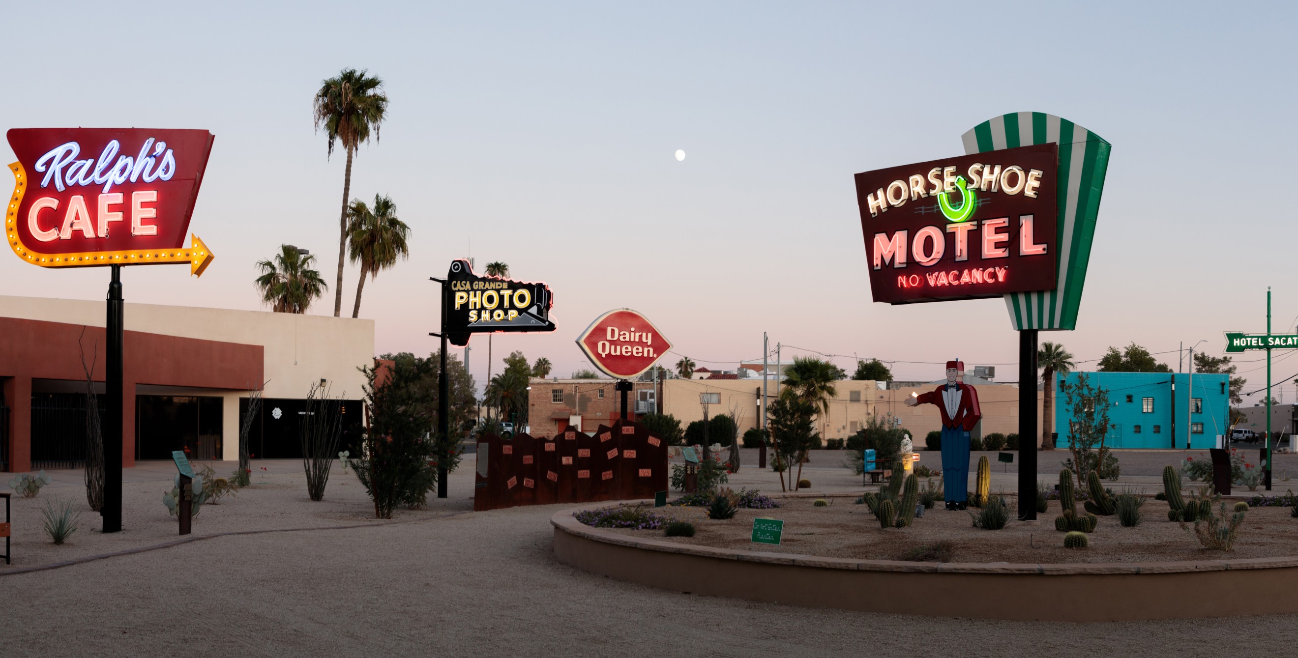 Signs lit up at desk at the Casa Grande Neon Sign Park in Arizona.