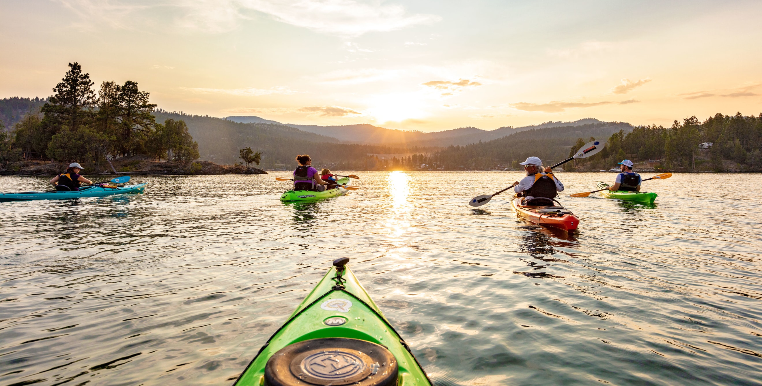 A family kayaks on Flathead Lake in Montana.