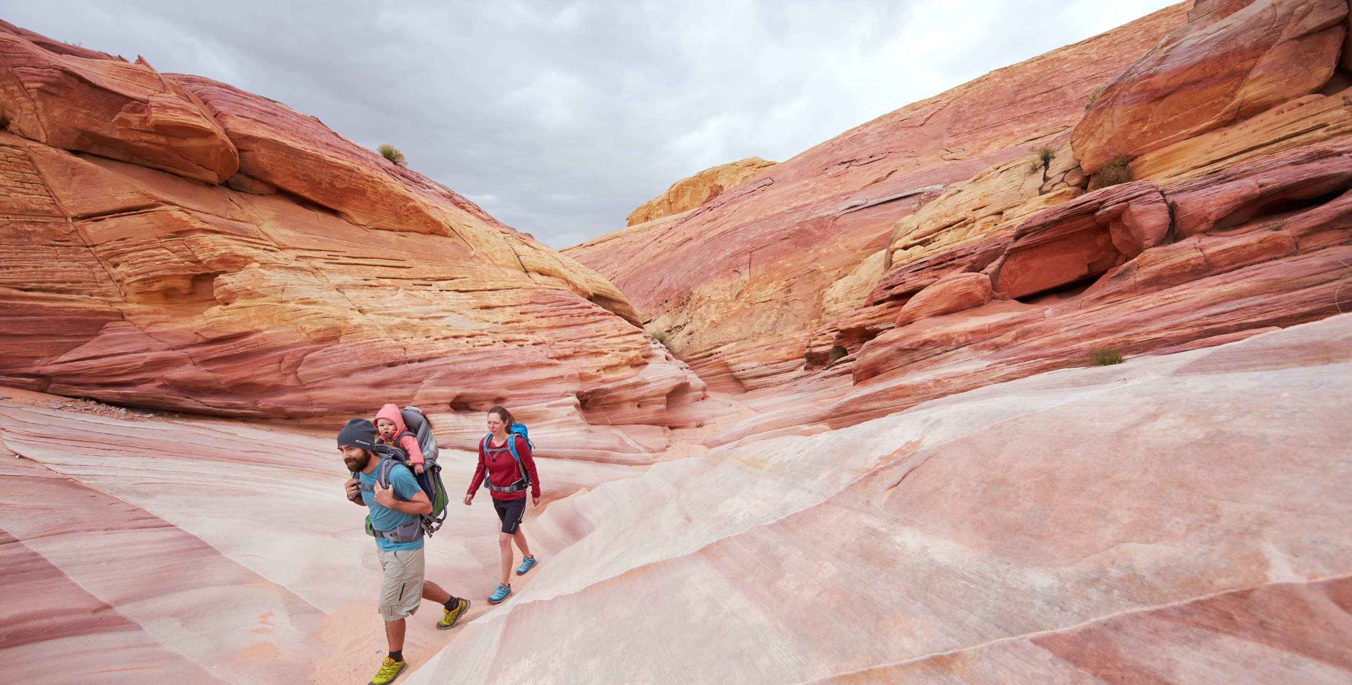 A family hikes through the vibrant rocks at Valley of Fire State Park, Nevada.