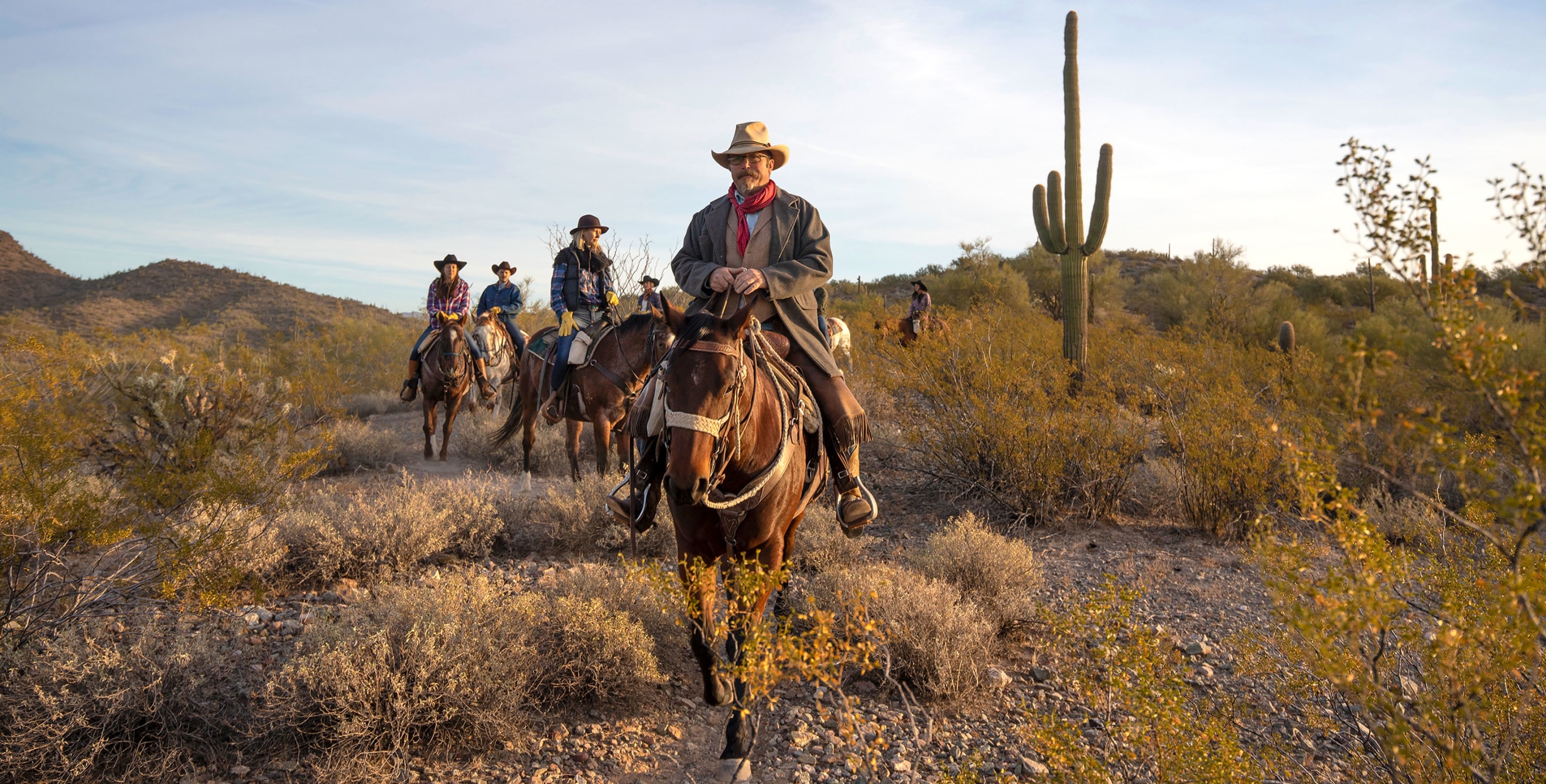 A group of riders meander through the desert at Kay El Bar Guest Ranch in Arizona.