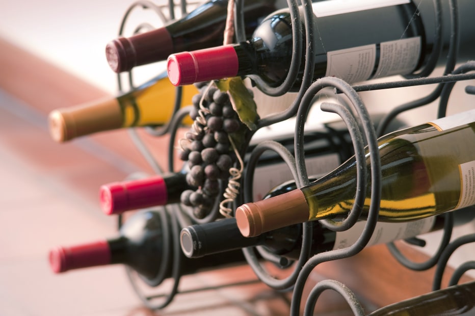 Wine bottles in a wire rack.