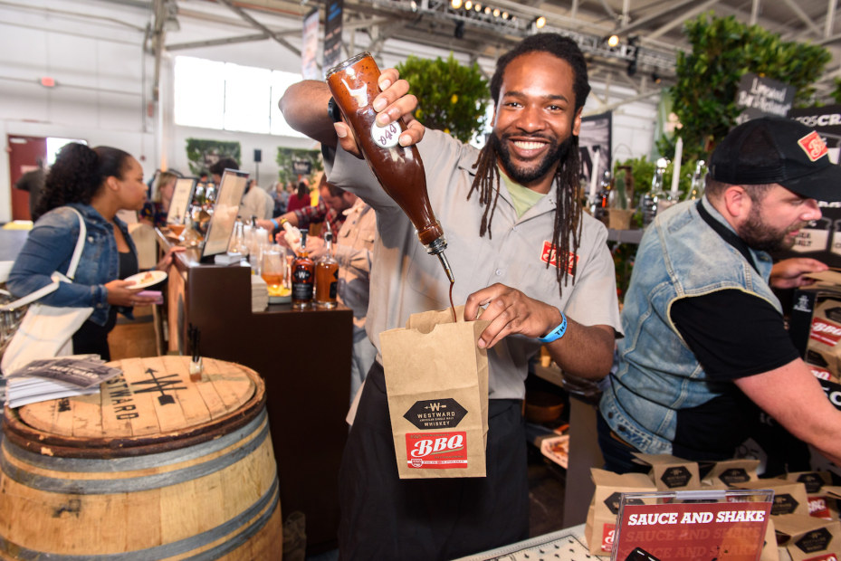  a vendor pours a drink at Eat Drink SF in Fort Mason Center, picture