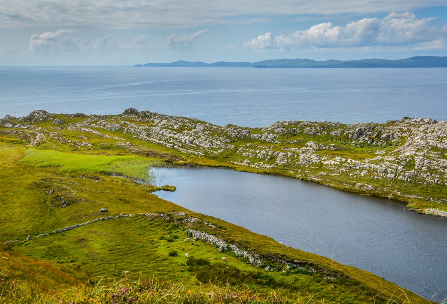 Rolling green hills and Lough Akeen in the Sheep's Head peninsula on the North Atlantic coast in Ireland, picture