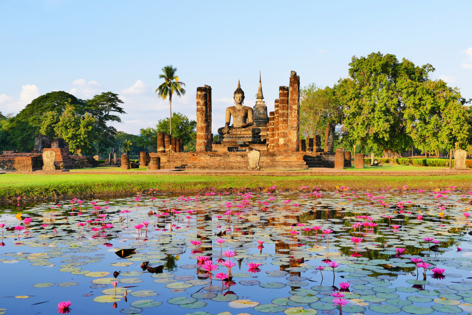 Ancient Buddhist temple ruins of Wat Mahathat in the Sukhothai Historical Park on a clear summer day, photo