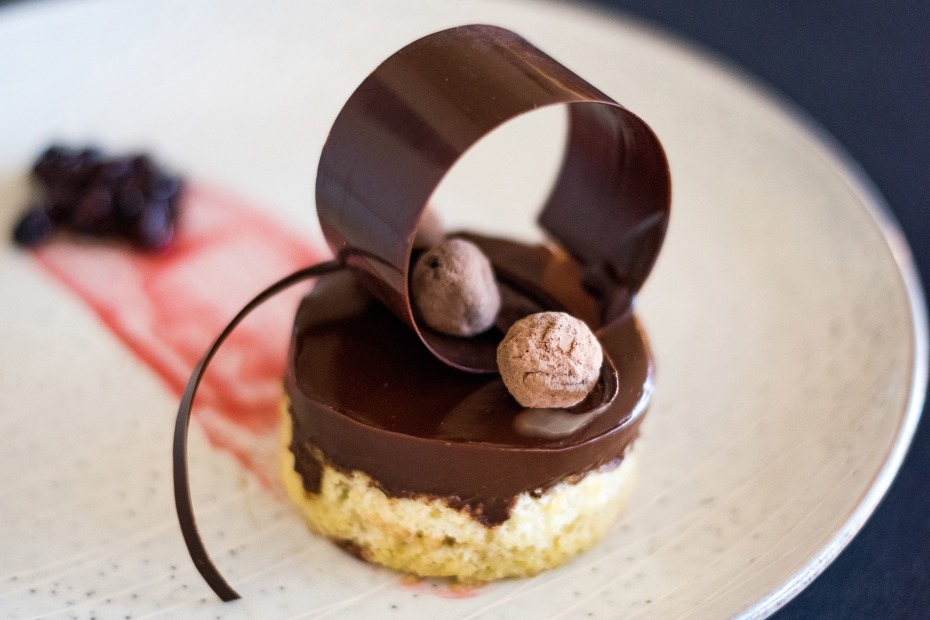 A cake with a chocolate ganache and chocolate roll sit on a plate at the Oregon Chocolate Festival in Ashland, Oregon, image