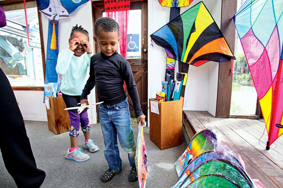 two kids look at kites on display at Once Upon a Breeze in Cannon Beach, picture