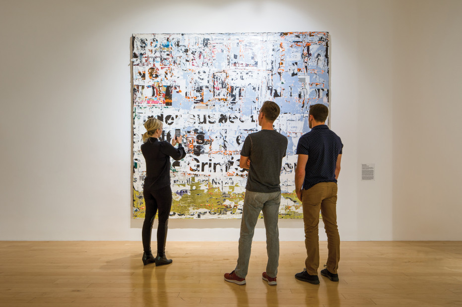 visitors to the Palm Springs Art Museum examine a work of art