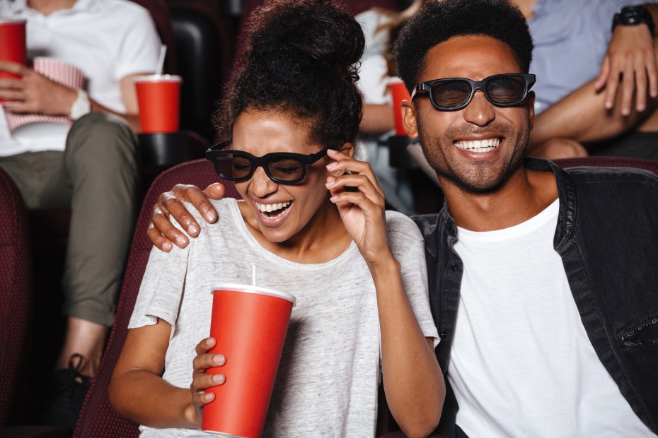 Picture of a couple laughing in a movie theater during a 3D movie with 3D glasses on, image