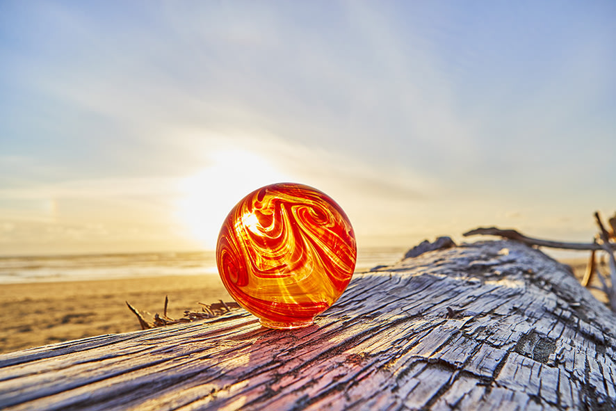 glass float by Finders Keepers glows at sunset on the beach in Lincoln City, Oregon, picture