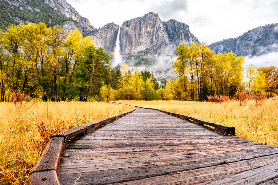 Boardwalk trail in Yosemite Valley in fall with full waterfall in the background, picture