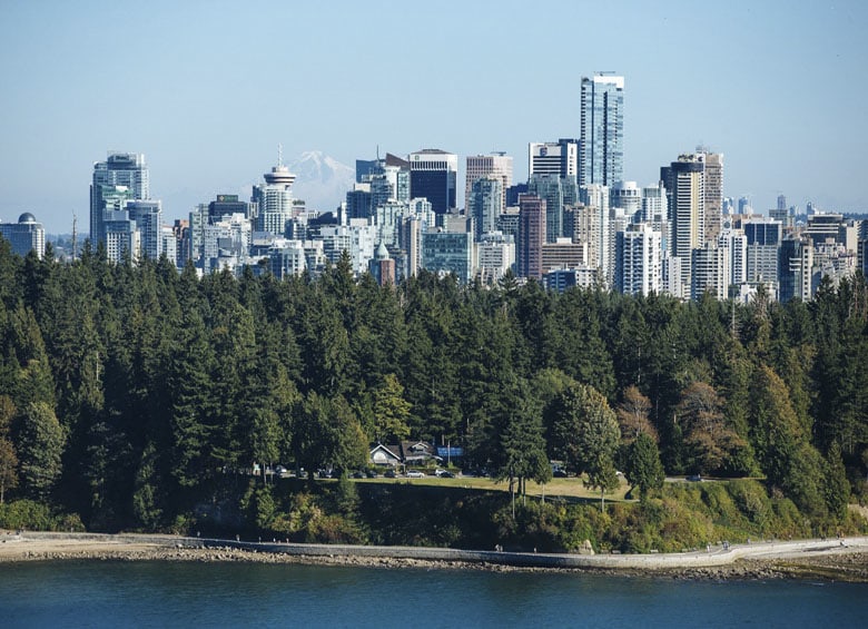 Teahouse at water's edge in Stanley Park with Vancouver, B.C., skyline in background  picture