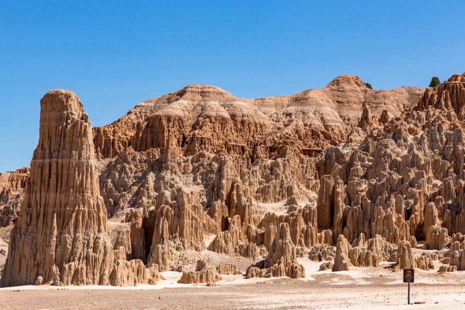 colorful rock formations rise up under blue skies at Cathedral Gorge State Park in Nevada, picture