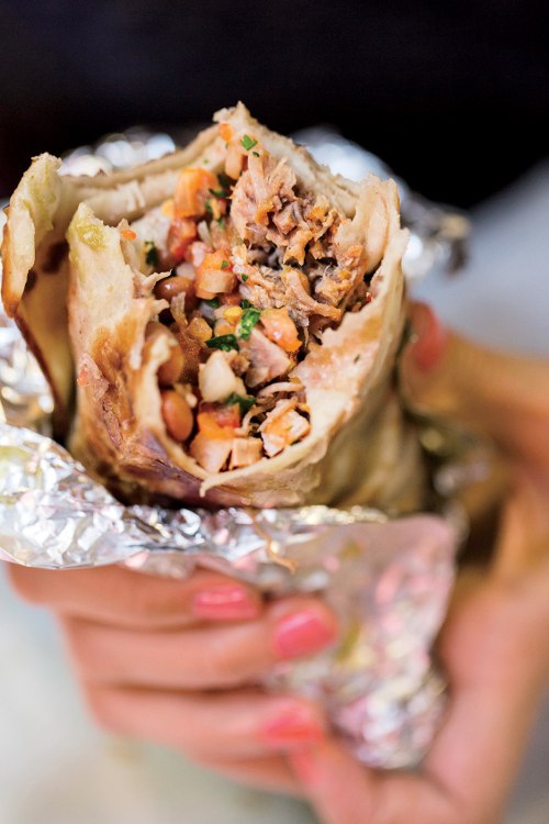 a foil-wrapped burrito from La Taqueria is filled with meat and beans, picture
