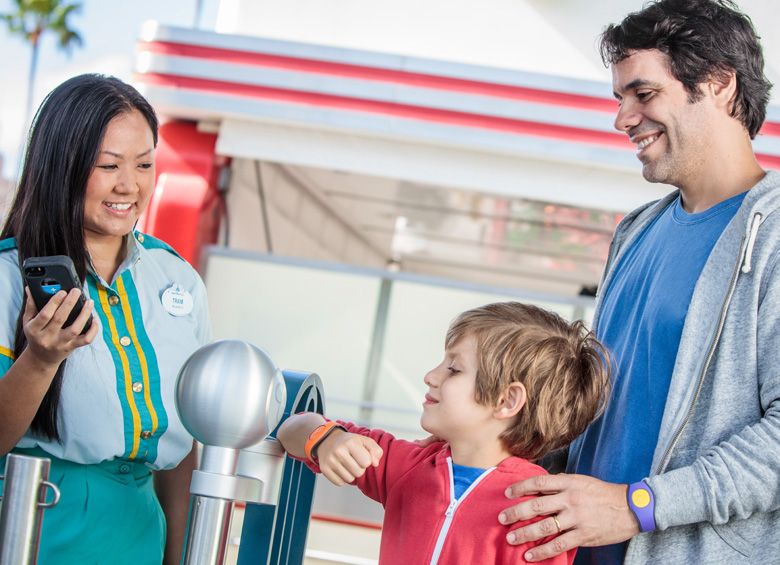 boy using MagicBand at Disneyland, picture