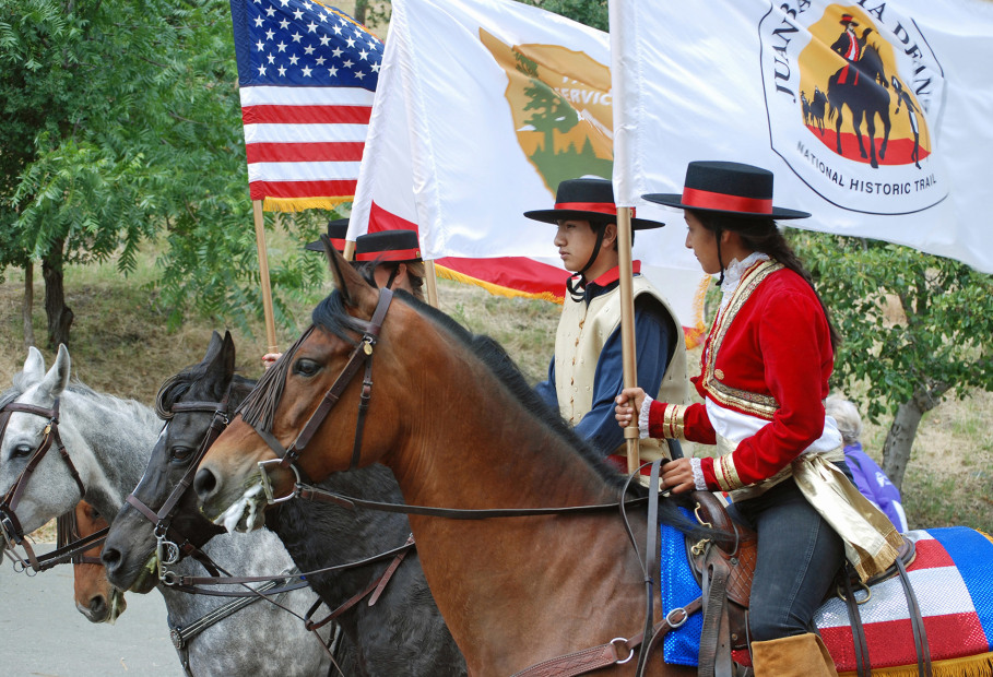  three riders of the Amigos de Anza color guard on horseback with flags, picture
