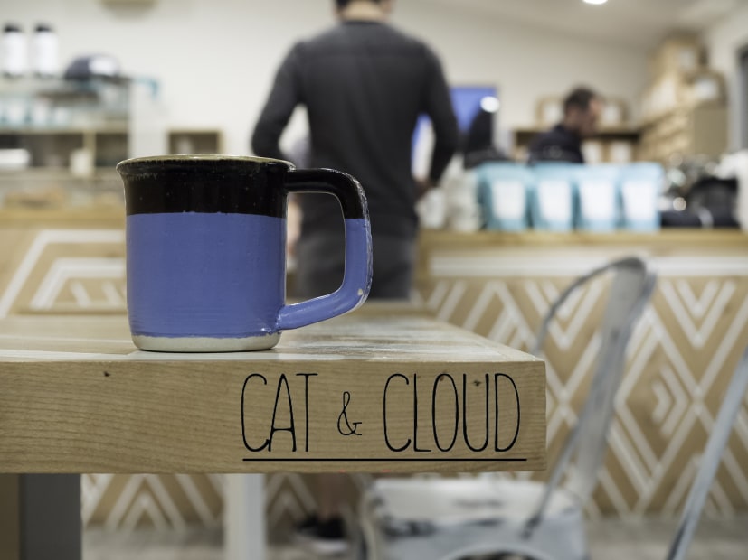 a mug atop table in Cat & Cloud's original Pleasure Point location in Santa Cruz, California, picture