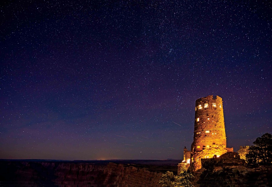 The Desert View Watchtower glows against the Arizona sky at Grand Canyon National Park, image