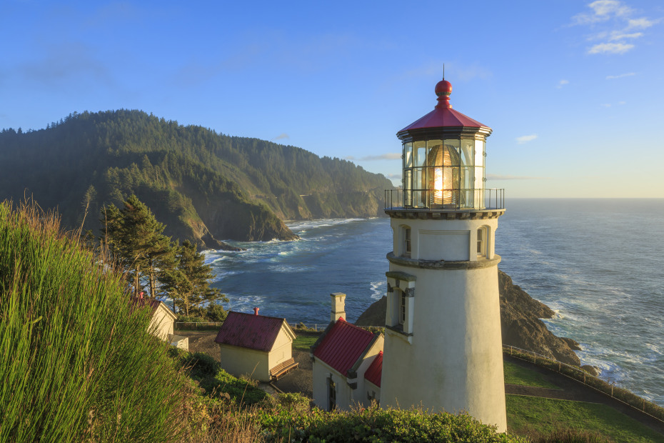 Heceta Head Lighthouse with the hills and ocean in background, picture