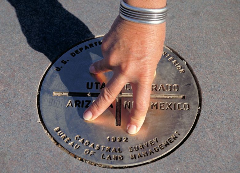 picture of hands posing on the Four Corners Monument plaque in the Southwestern United States