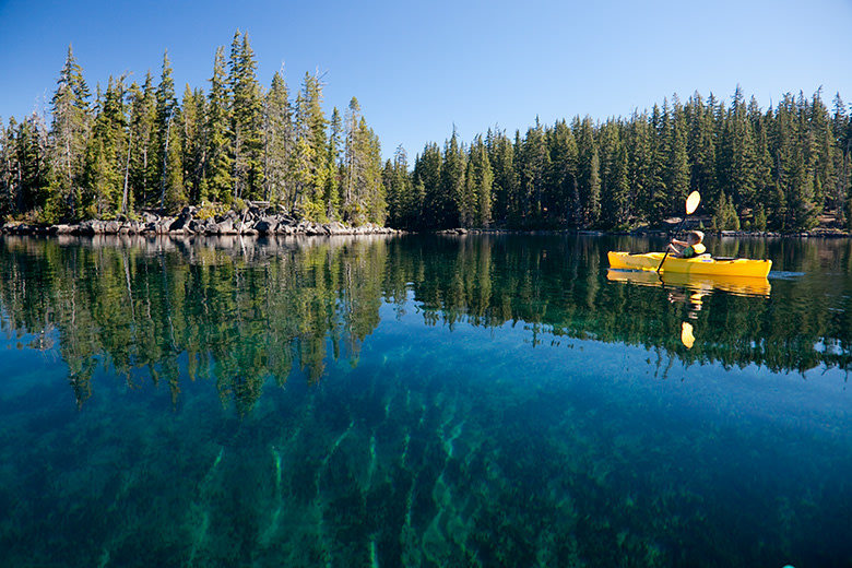 kayaker paddles on the crystal clear waters of Oregon's Waldo Lake in the Cascade Range, picture