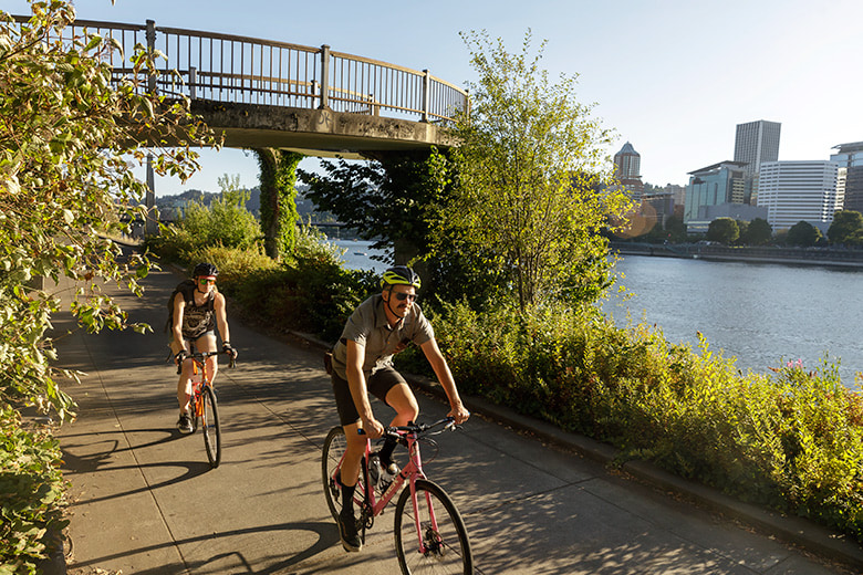 cyclists biking along Portland, Oregon's Eastbank Esplanade, picture