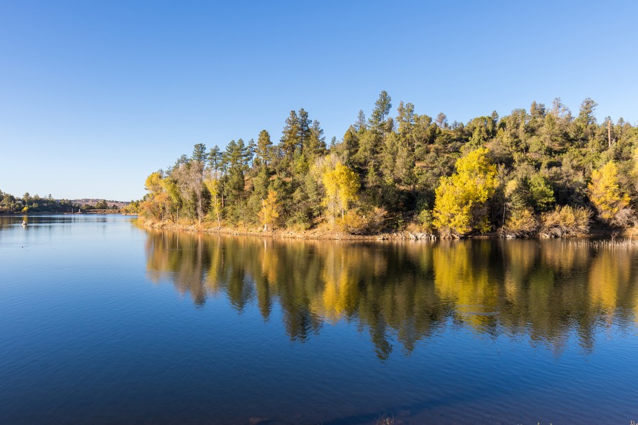 Fall colors reflect on a calm Lynx Lake in Prescott, Arizona in autumn, photo