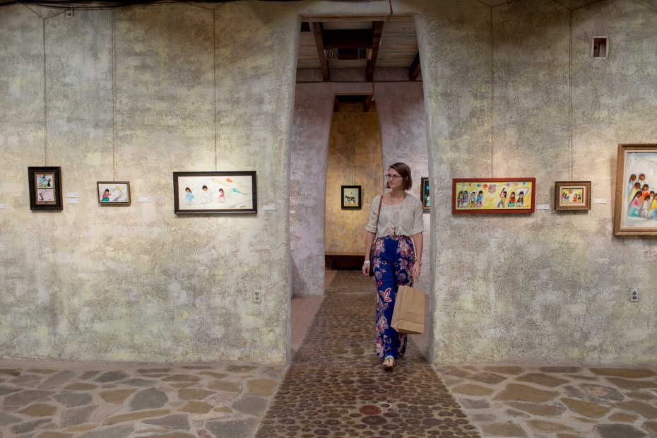 young woman stands in exhibit archway at DeGrazia Gallery in the Sun in Tucson, Arizona, picture