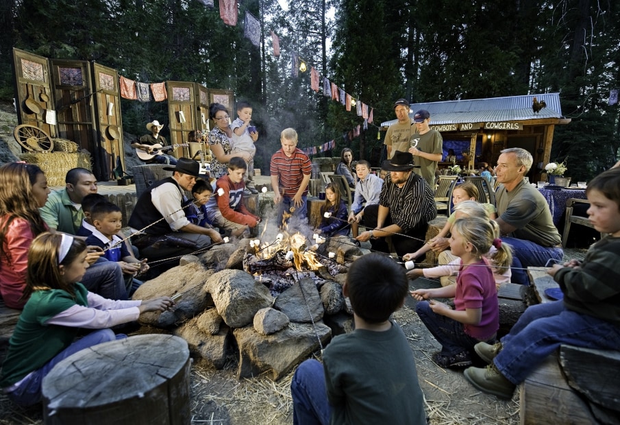 families gather around a fire pit to roast marshmallows at the Tenaya Lodge in Fish Camp, California, picture