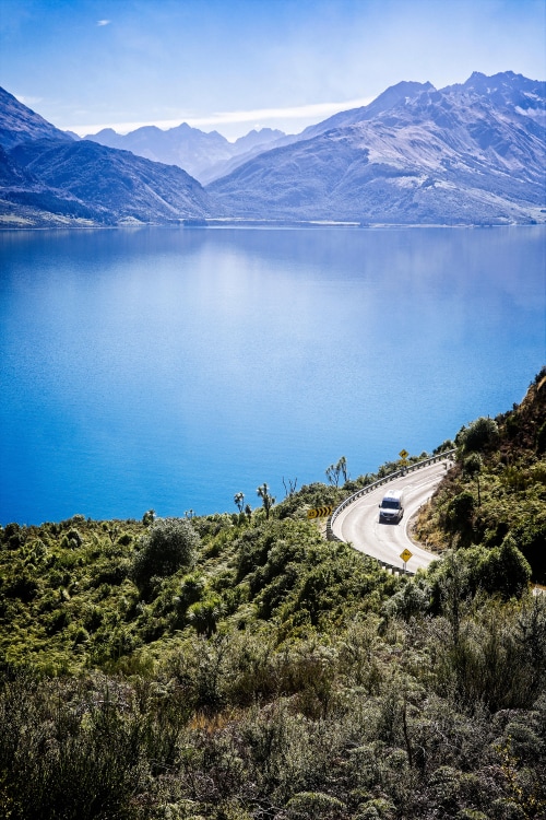 aerial view of solo car on Glenorchy-Queenstown Road beside Lake Wakatipu in New Zealand, picture