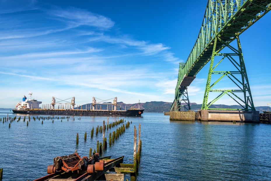 View of the Astoria Megler Bridge in Astoria, Oregon, with a tanker ship about to pass beneath it