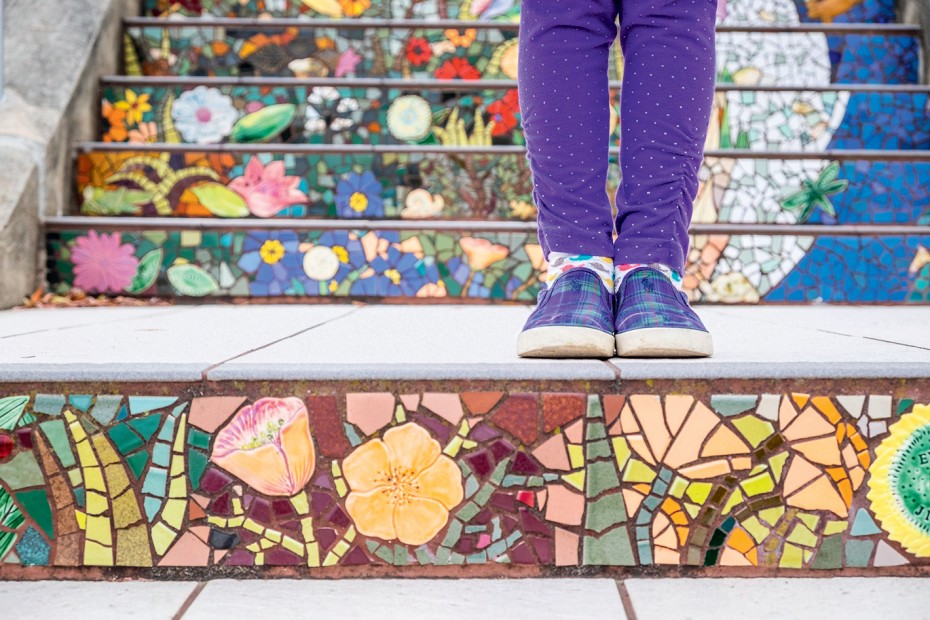 person in purple pants stands on 16th Avenue Tiled Steps in San Francisco's Sunset District, picture