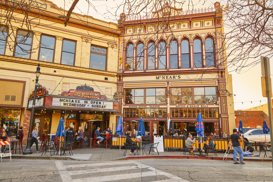 exterior of McNears Saloon and the Mystic Theatre with patrons sitting outside