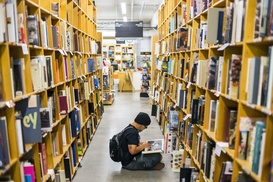 Man dressed all in black browses at Powell's Books in Portland, Oregon, picture