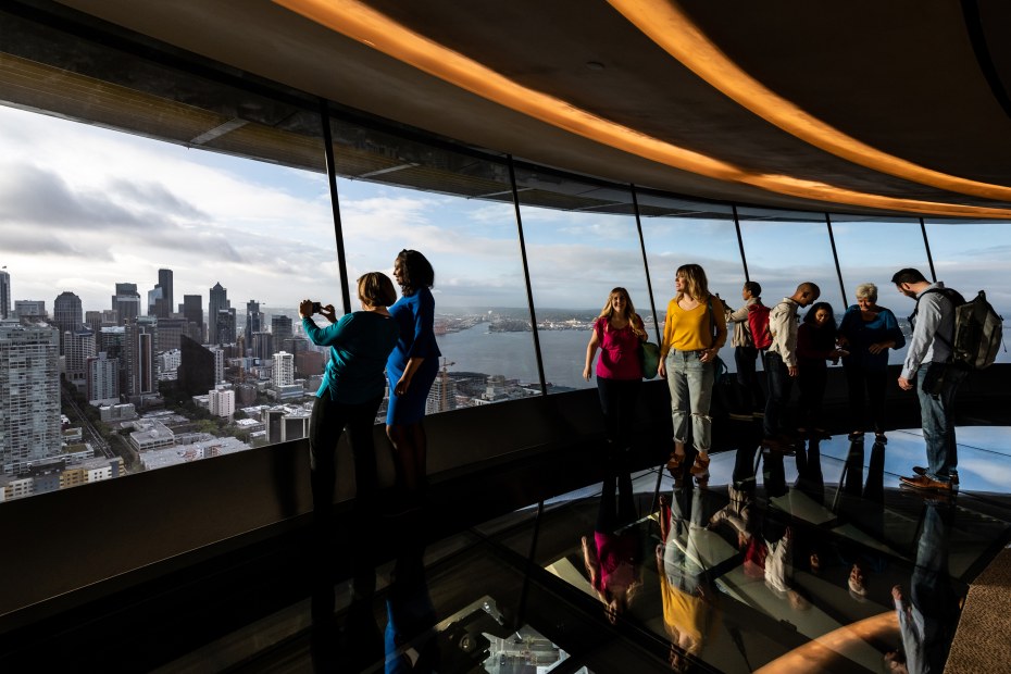 picture of visitors checking out the view of the Seattle skyline from the Loupe, the Space Needle's new revolving floor