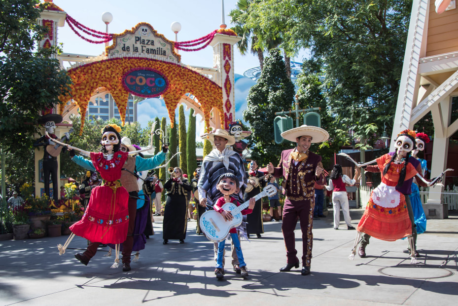 The daily Dia De Los Muertos parade in the Coco-inspired Plaza de la Familia during Halloween Time at Disney California Adventure