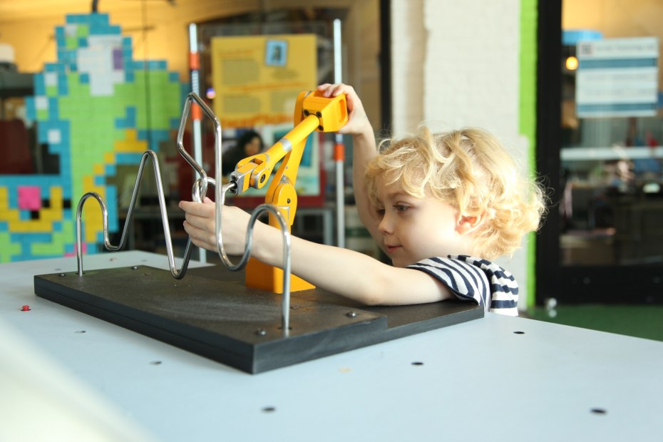 Child playing in Oregon Museum of Science and Industry Turbine Hall, picture