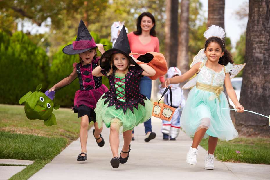 Mother takes kids trick-or-treating, picture