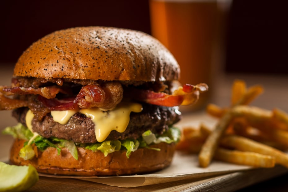 bacon burger with melted cheese over lettuce with fries at Michael Mina Pub 1842 in the MGM Grand in Las Vegas, Nevada, picture