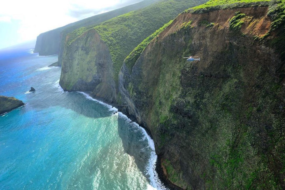 Picture of a Paradise Helicopter touring above the Kona Coast and sparkling Pacific