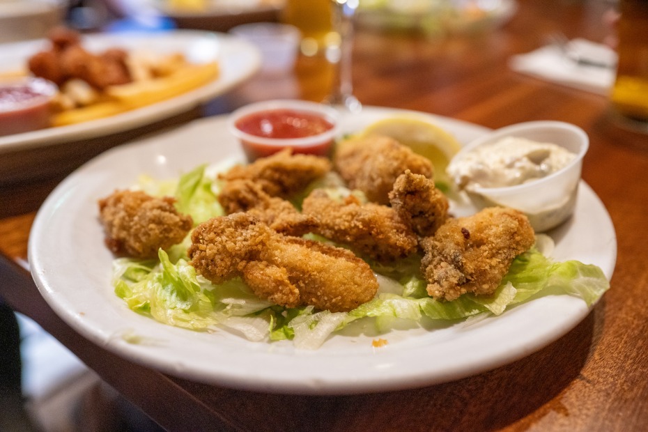 a plate of fried oysters with dipping sauces at Gracie's Sea Hag in Depoe Bay