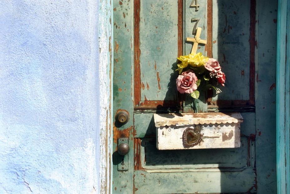 faux flowers in a mail box on a green doorway in Tucson's Barrio Viejo neighborhood. 