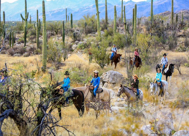 visitors to Tanque Verde Guest Ranch ride horses, picture