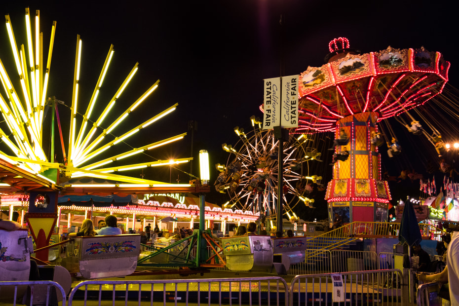 Carnival rides and games glow neon after dark at the California State Fair, photo