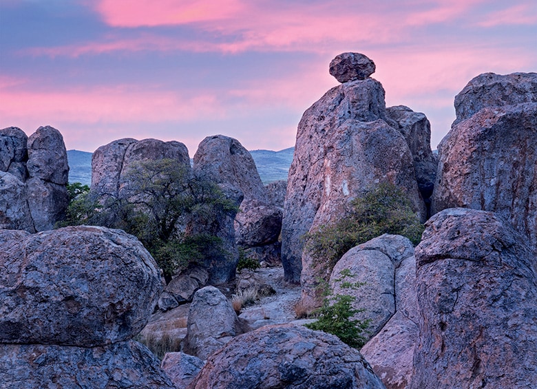 rock formations of volcanic ash eroded by water and wind up close in dramatic magenta and blue light at The City of Rocks State Park, New Mexico, picture