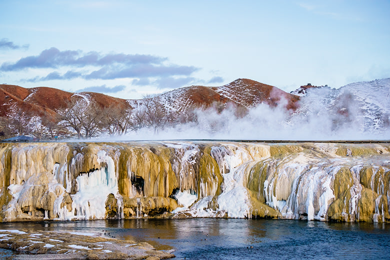 steam rises from snow-lined travertine terrace at natural springs at Hot Springs State Park in Thermopolis, Wyoming, picture