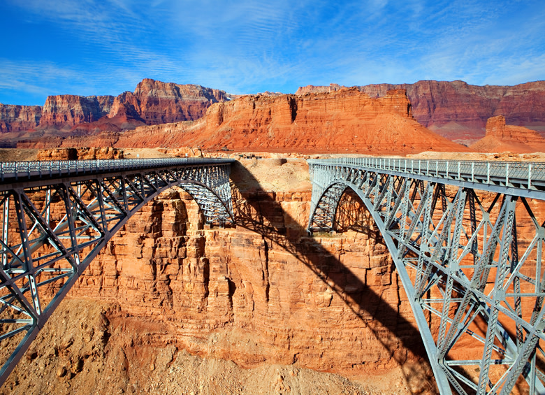the twin pedestrian spans of Navajo Bridge cross over the Colorado River in Grand Canyon National Park in Arizona, picture