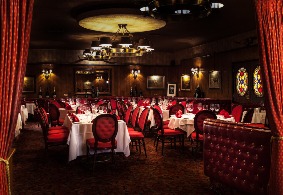 the interior of Golden Steer Steakhouse in Las Vegas, Nevada, features red leather and dark lighting, picture