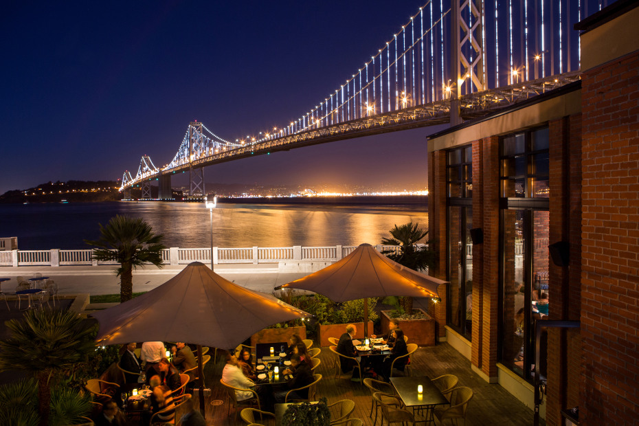 the patio at Waterbar in San Francisco, California, set against the Bay Bridge's Bay Lights, picture